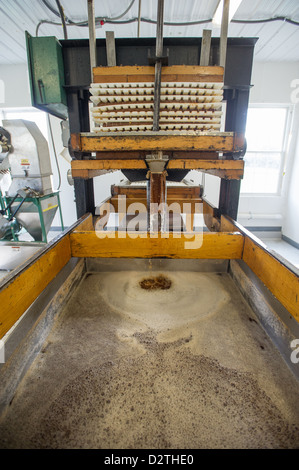 Apples, apple juice and cider press at a hard cider distillery  Stock Photo