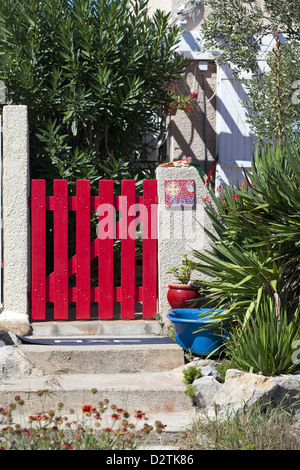 Red wooden garden gate to a cottage in southern France, Gruissan Stock Photo