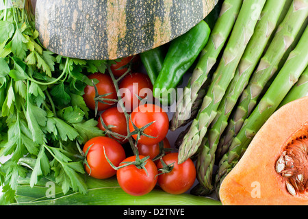 Fresh multicolored vegetables, parsley, cherry tomatoes, pumping, asparagus. Stock Photo