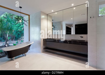 Luxury bathroom with mirror, sink and classic bathtub Stock Photo