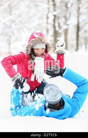 Winter couple snowball fight. Young couple having fun in snow outside. young couple in their twenties Stock Photo
