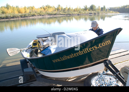 Tailwater Drifters guide launching a drift boat for a catch & release float trip fly fishing on the Red Deer River, Alberta,CA. Stock Photo