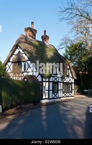 Traditional thatched cottage on rural road in English countryside village. Pangbourne, Berkshire, England, GB, UK Stock Photo