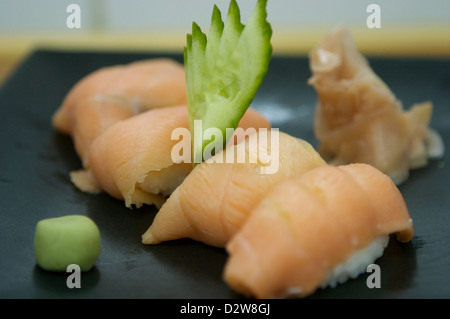Salmon nigiri  with wasabi, pickled ginger and cucumber. Stock Photo