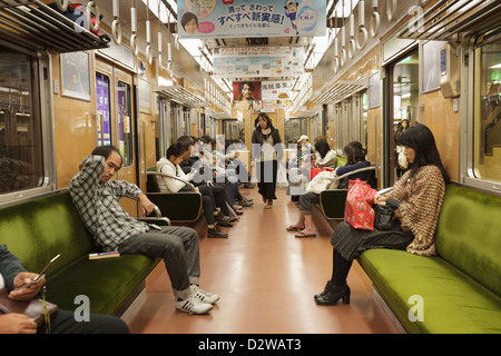 Passengers inside suburban commuter train, Kyoto, Japan Stock Photo