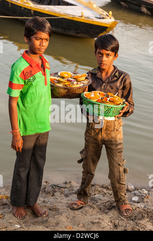 boys selling Marigolds, Varanasi, Inida Stock Photo