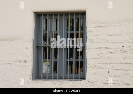 A barred window in an old building near Old Fisherman's Wharf in Monterey, California. Stock Photo