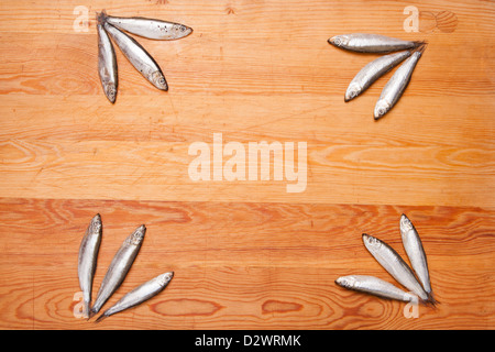 salted anchovies in group on wooden background Stock Photo