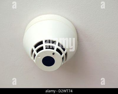 Smoke detector mounted to the ceiling Stock Photo