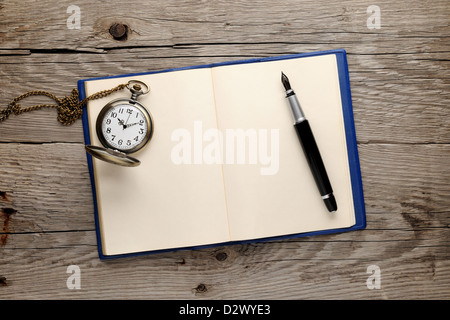 Antique watch and fountain pen on old note book Stock Photo