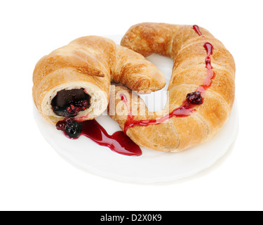 fresh and tasty croissant with chocolate and raspberry jam on plate isolated on white background Stock Photo