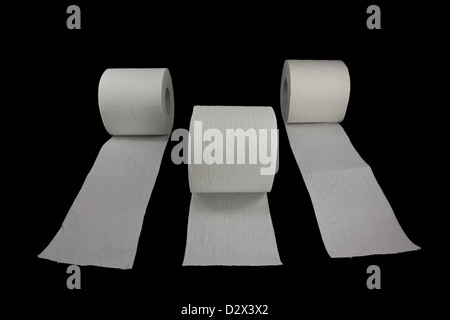 Picture of three toilet rolls racing on a black background Stock Photo