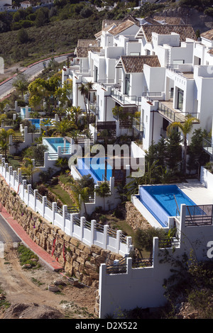 Row of white villas each with a swimming pool in Benalmdena Costa del Sol Spain Stock Photo