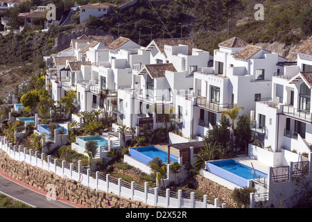 Row of white villas with swimming pools in Benalmadena Costa del Sol Spain Stock Photo