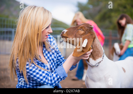 Children on livestock farm taking care of animals Stock Photo