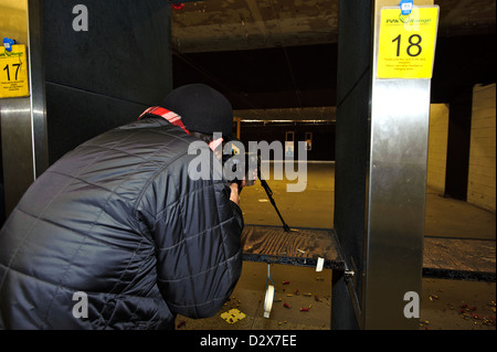 Target shooting with an AR-style target rifle at an indoor range Stock Photo