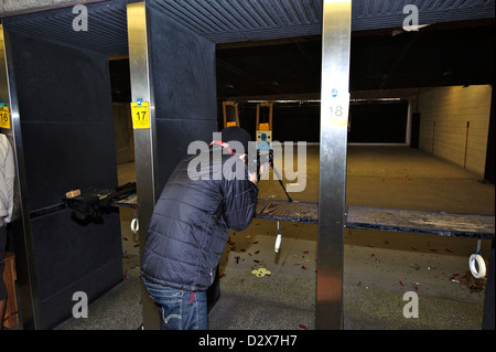 Target shooting with an AR-style target rifle at an indoor range Stock Photo