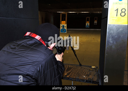 Target shooting with an AR-style target rifle at an indoor range Stock Photo