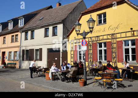 Werder, Germany, guests sit in front of the Gallery Cafe on the market Stock Photo
