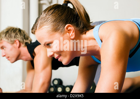 Couple in a gym performing gymnastics Stock Photo