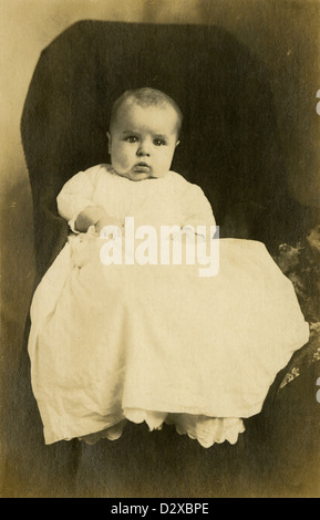 Circa 1910s photograph, cute baby about 3-6 months old with large cheek jowls. Stock Photo