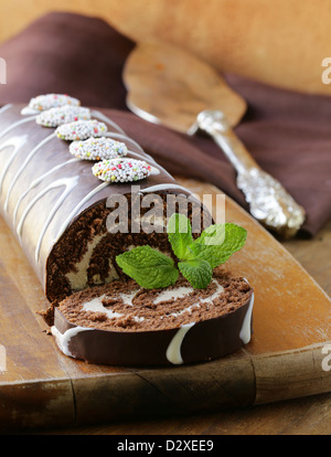 chocolate cake  roll with vanilla cream on a wooden board Stock Photo