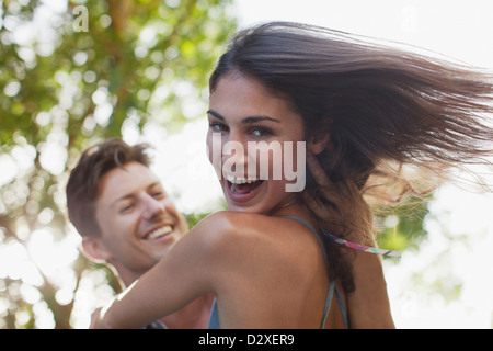 Close up of man spinning smiling girlfriend Stock Photo