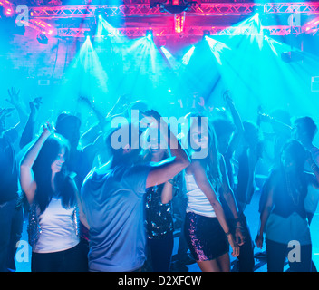 People dancing on dance floor of nightclub Stock Photo