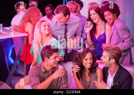 Smiling friends drinking champagne in nightclub Stock Photo
