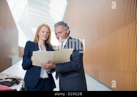 Businessman and businesswoman reviewing paperwork Stock Photo