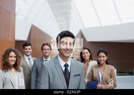 Portrait of confident business people in modern lobby