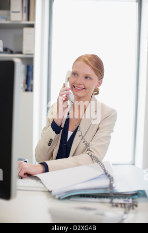 Smiling businesswoman talking on telephone Stock Photo