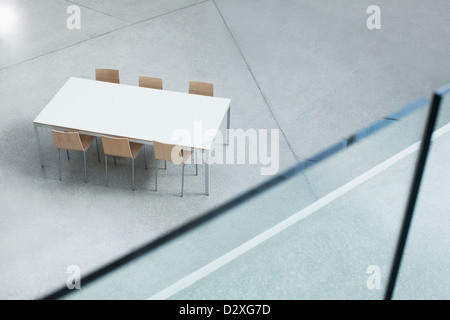 Table and chairs in empty lobby Stock Photo