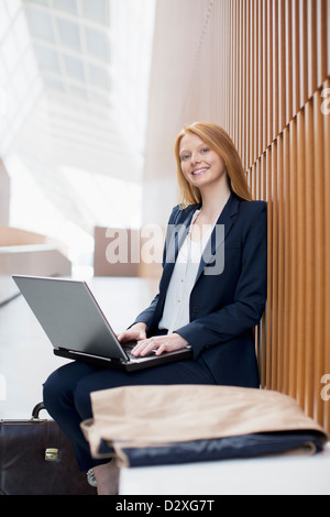 Portrait of smiling businesswoman using laptop Stock Photo