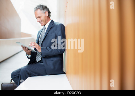 Businessman using digital tablet in office Stock Photo