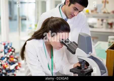 Scientists using microscope in laboratory Stock Photo