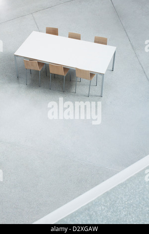 Table and chairs in empty lobby Stock Photo