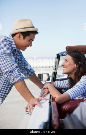 Smiling couple talking in convertible Stock Photo