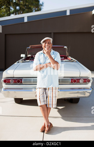 Smiling older man with convertible Stock Photo