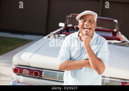 Older man smiling with convertible Stock Photo