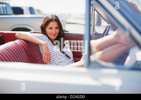 Smiling woman sitting in convertible Stock Photo