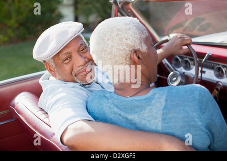 Older couple sitting in convertible Stock Photo