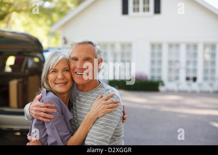 Smiling older couple hugging outdoors Stock Photo