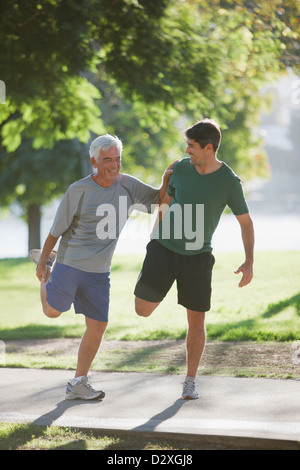 Older man stretching with trainer Stock Photo