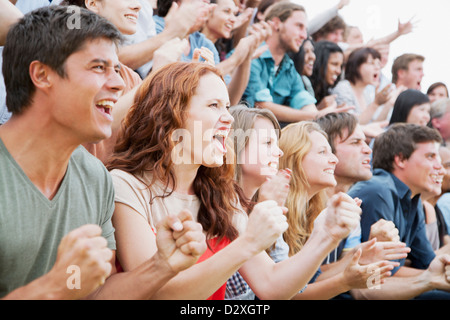 Fans cheering in crowd Stock Photo