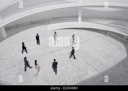 Business people walking in modern courtyard Stock Photo