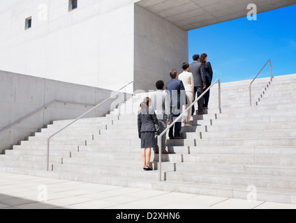 Business people standing in a row on urban stairs Stock Photo
