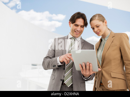 Businessman and businesswoman using digital tablet Stock Photo