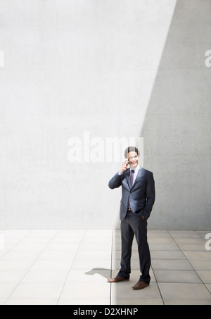 Smiling businessman talking on cell phone Stock Photo
