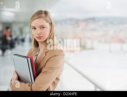 Portrait of serious businesswoman at window Stock Photo